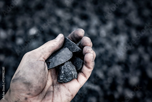 Black coal in hand. Thermal energy industry. Heating. Mineral raw materials. Natural energy stones.