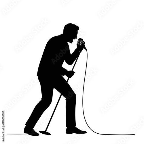 Silhouette of a male singer performing live on stage holding a vintage microphone and singing loudly