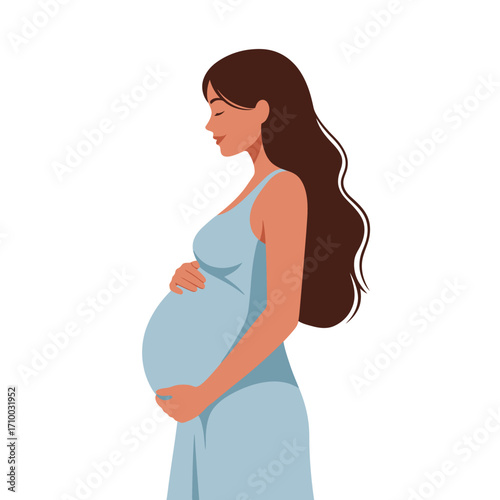 Beautiful pregnant woman in a light blue dress holding her belly with a gentle smile