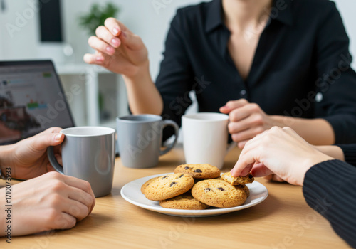 Colleagues Sharing Homemade Cookies in Office Break Room. National Homemade Cookies Day