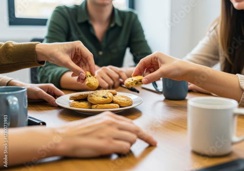 Colleagues Sharing Homemade Cookies in Office Break Room. National Homemade Cookies Day