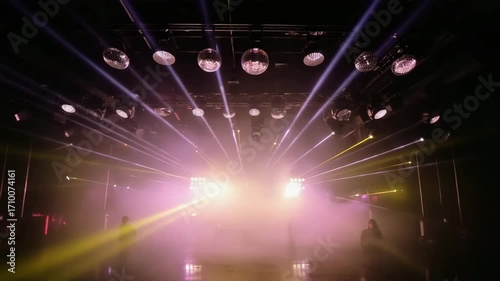 A dark club dense fog dozens of tiny lasers shoot downward rain, bouncing floor walls. Flashing blinder lights, disco bulbs halogen headlamps bursts. tracking low-angle lens flares on smoke