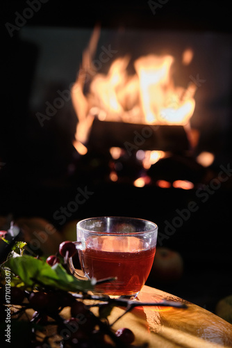 Cozy evening scene with a warm drink by the fireplace