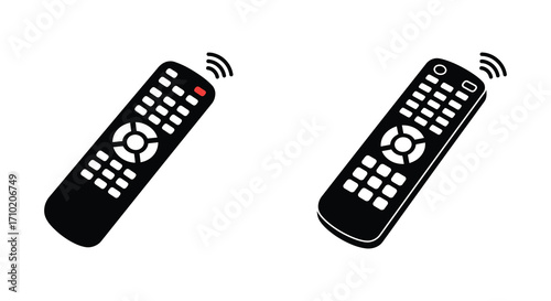 Two black remote controls with buttons viewed from a slightly angled perspective
