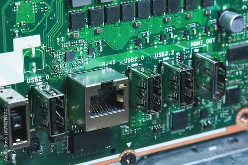 Close-up image of an all-in-one computer interior showing the motherboard, heat pipe cooling system, RAM slot, processor, and electronic components. Inside View of All-in-One Computer Motherboard