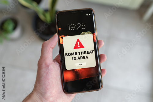 Bomb threat urgent notification on smartphone.