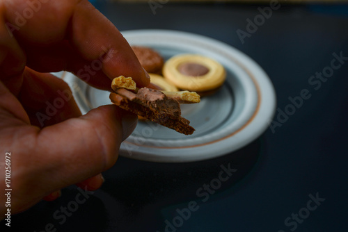 Fotografie When you hold the biscuit called Noblice in your hand, you can't resist taking a bite, where you can see exactly the texture of what it's made of and you can see the two types of chocolate