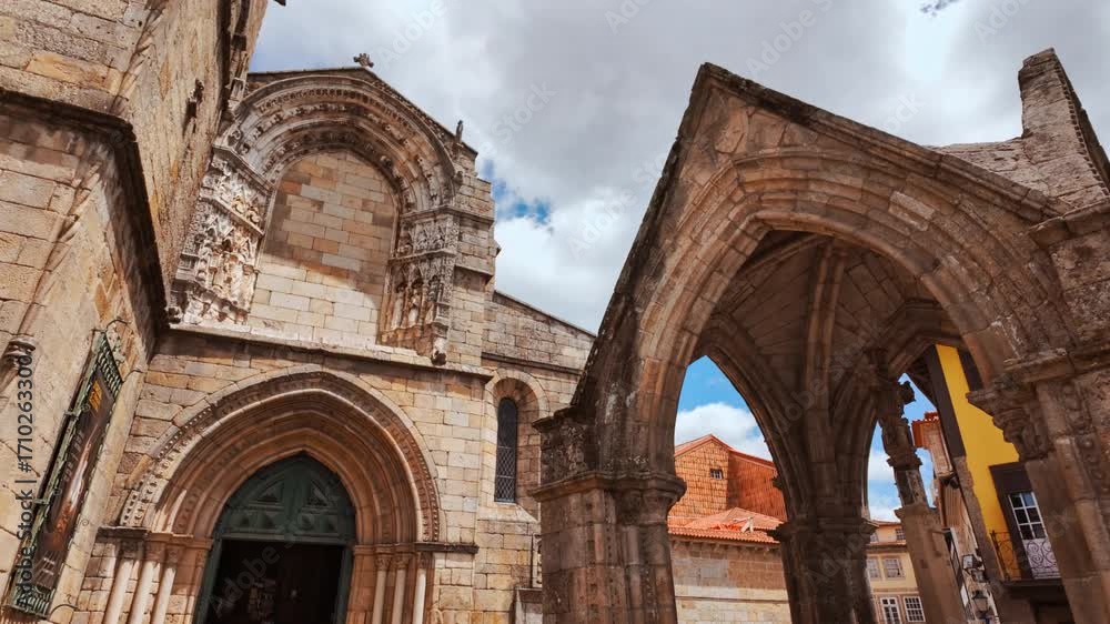 Largo da Oliveira Square in Guimaraes, Portugal features medieval arcades the Padrao do Salado monument and timber framed houses encircling lively cafe terraces