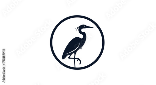 Minimalist silhouette of a heron standing gracefully on one leg within a circular emblem.