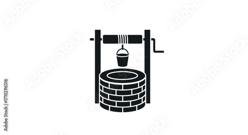 A classic brick water well with a bucket and crank mechanism.