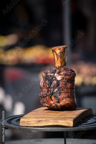 Barbequed pork knuckle on a wooden plate