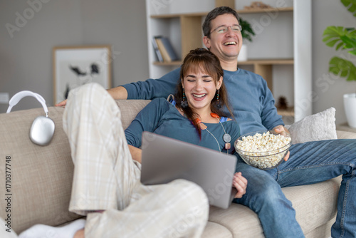 Friends enjoy a cozy movie night at home while sharing laughter and popcorn