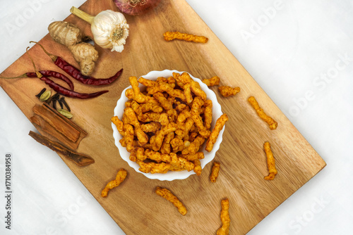 Bowl of home made potato chips made with rice, mustard, rosemary, fleur, salt, onion and chili on white background. Indian tea snacks, namkeen concepts. Top view. Copy space