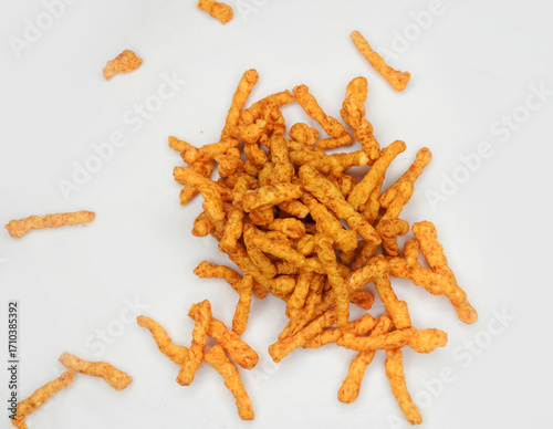 Heap of Crunchy spicy snacks isolated on white background. red chilli powder snack isolated on white background. Indian tea snacks concepts.