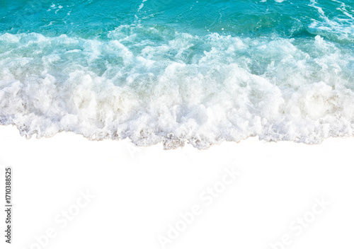 Waves crashing on sandy beach with foamy water creating dynamic and refreshing scene