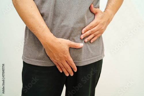 Hernia, Asian man stomach ache, abdominal pain and urology problem health.