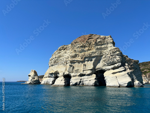 rock in the sea by a greek island