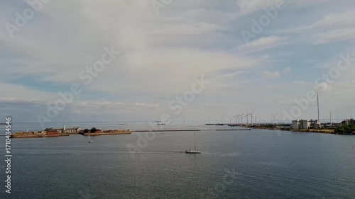 Denmark Østerbro sep 2 2024 Open Coastal Scene with Island, Wind Turbines, and a Sailing Boat