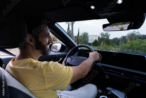 Father driving car with his daughters on summer vacation in spain