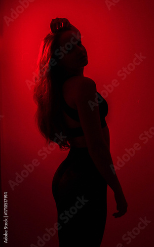 Dreamy Portrait, silhouette and double exposure, of a brunette in Orange-Pink-Red Glow