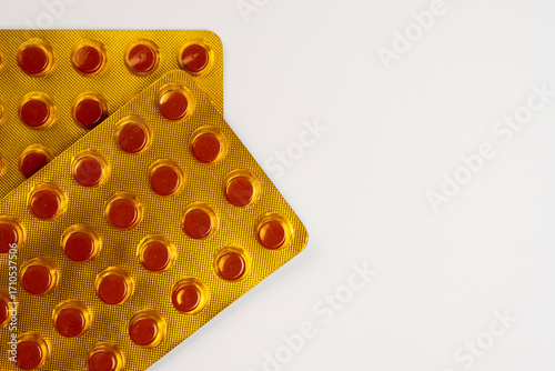 Yellow blister pack of tuberculosis tablets isolated on a white background with a coffee space. Tuberculosis medication in the pack in the 4th month of consumption period.