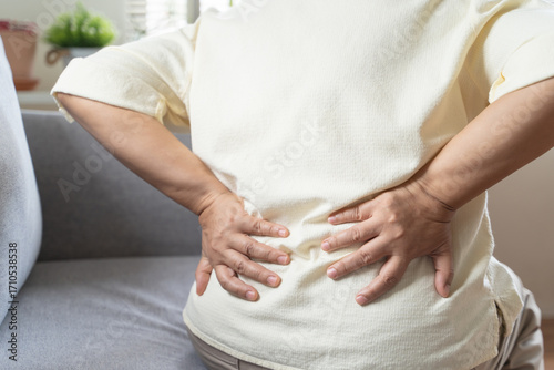 Wallpaper Mural Older woman feeling back pain at home Torontodigital.ca