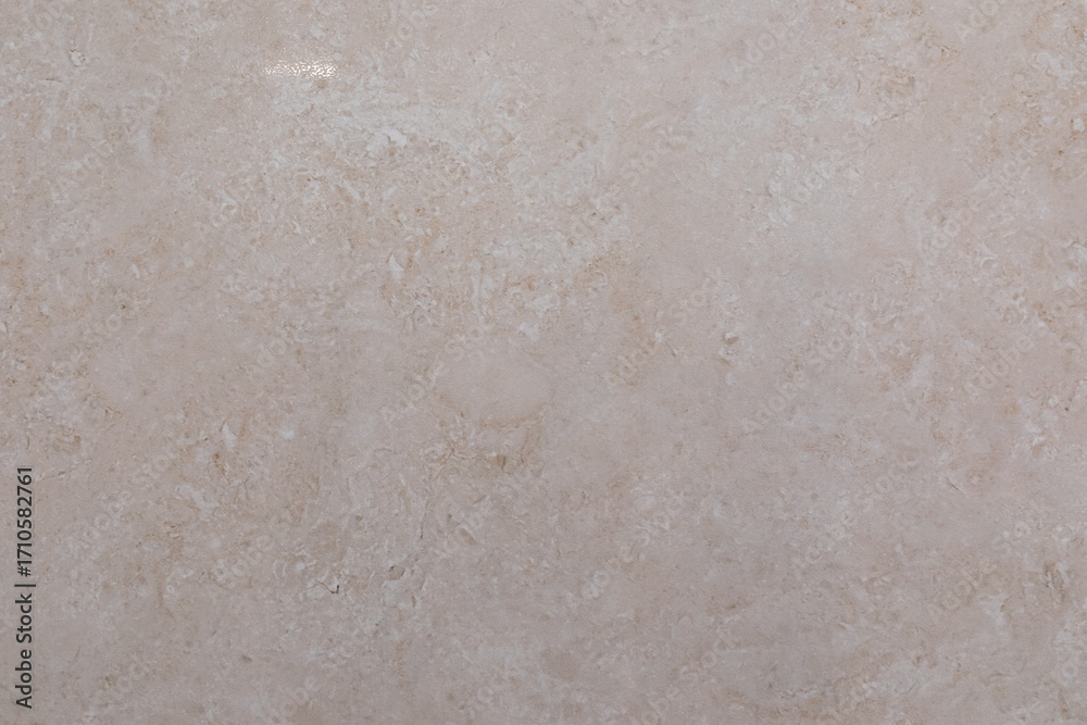Fototapeta premium Smooth beige stone surface showcasing natural patterns and textures ideal for home decor