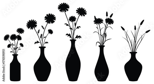 A collection of delicate black silhouette flowers in glass vases