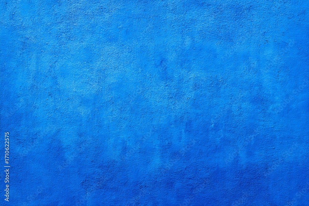 Fototapeta premium Vibrant textured blue wall background with subtle variations
