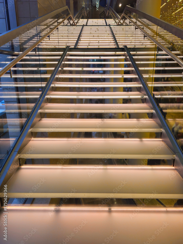 Obraz premium Staircase with illuminated steps in a modern interior