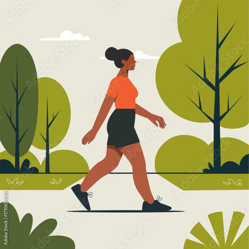 Woman walking on a path in a park. The background features green trees, trunks and foliage.