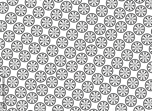 Intricate black and white pattern of repeating circular motifs with radial symmetry