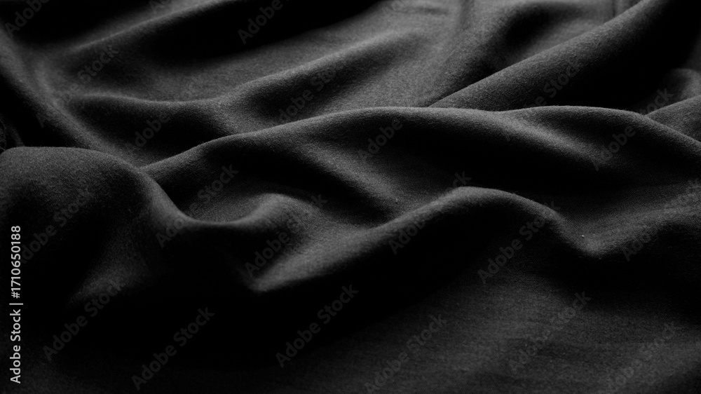 Fototapeta premium Black fabric texture background with soft rippled. Texture background of black clothing. Dark, wave, cotton, luxury, elegant, modern concept for wallpaper, cover, textiles. Close-up fabric surface.