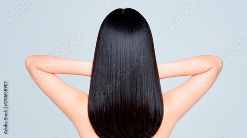 Asian female with smooth straight black hair posing from back view