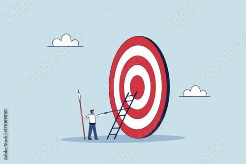 Aiming for high target mission, businessman with big ladder in his hand, starting to climb the ladder to bullseye