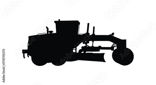 A black silhouette of a heavy machinery road grader on white background