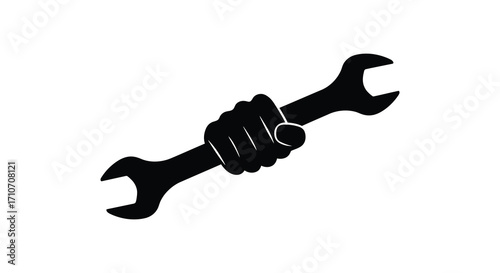 A clenched fist firmly gripping a large black wrench in isolation