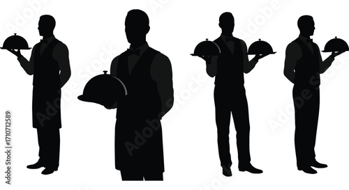 Silhouettes of waiters presenting dishes under silver cloches formal dining