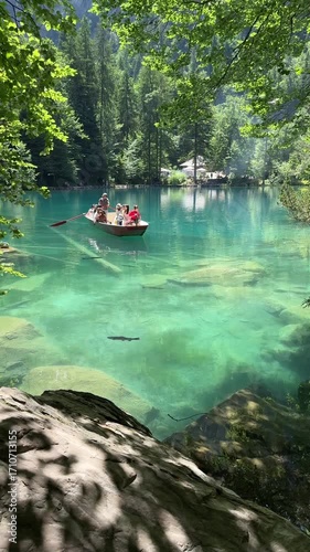 Crystal-clear Blausee lake in Switzerland, where the water is so transparent you can see fish swimming below. Pristine alpine nature, peaceful atmosphere, and stunning natural beauty. Kandergrund 