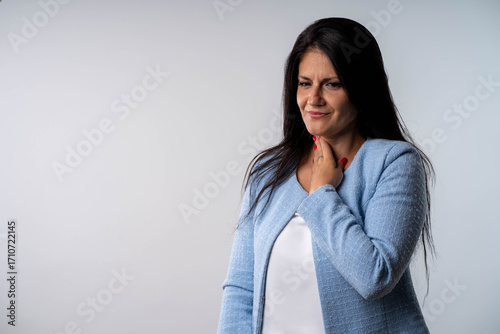 Concerned businesswoman touching throat feeling pain possible thyroid problem
