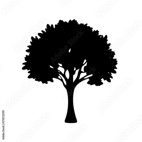 A stark silhouette of a lush and leafy tree stands tall alone