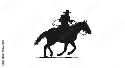 A silhouetted cowboy expertly riding a horse with a lasso in hand