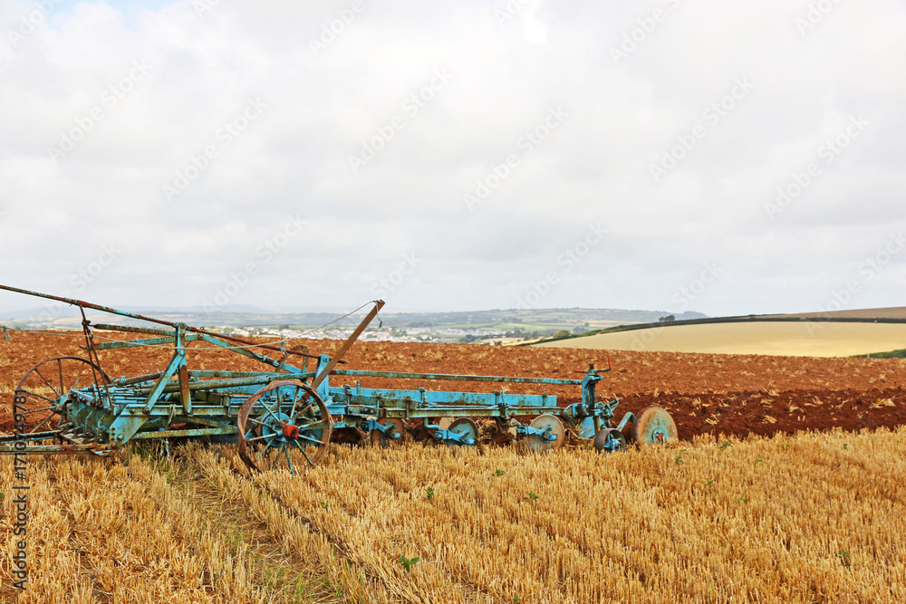 Fototapeta premium Vintage tractor ploughing a field 