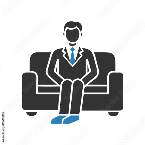 businessman sitting on the sofa .handsome businessman in suit sitting on sofa and holding smartphone
