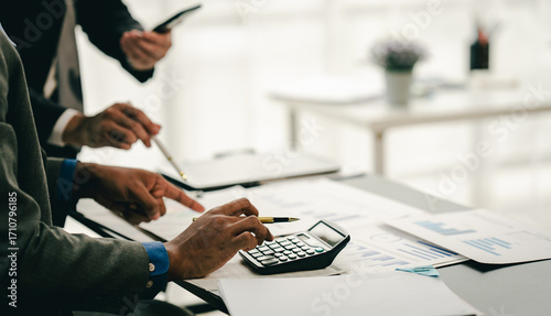 Young colleagues discuss business brainstorming and price charts analyze business people at the desk brilliantly in modern collaborative office teamwork ideas. Calculate personal tax for customers