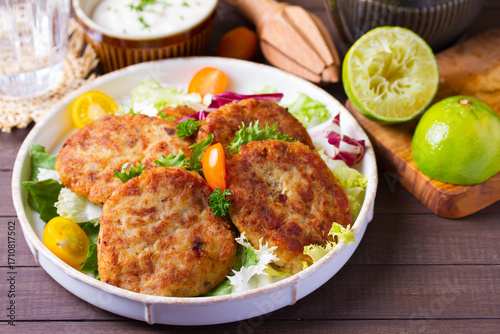 Fish patty burgers served with vegetables. Fish cakes