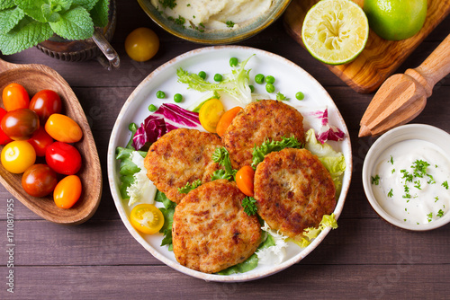 Fish patty burgers served with vegetables. Fish cakes. High angle view