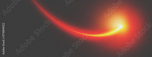 Abstract swirling light streak with bright yellow and red glow on a dark gray background