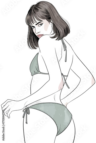 Stylish woman in bikini posing with a confident gaze, highlighting summer fashion.