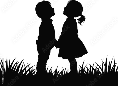 Two children holding hands and looking up in silhouette